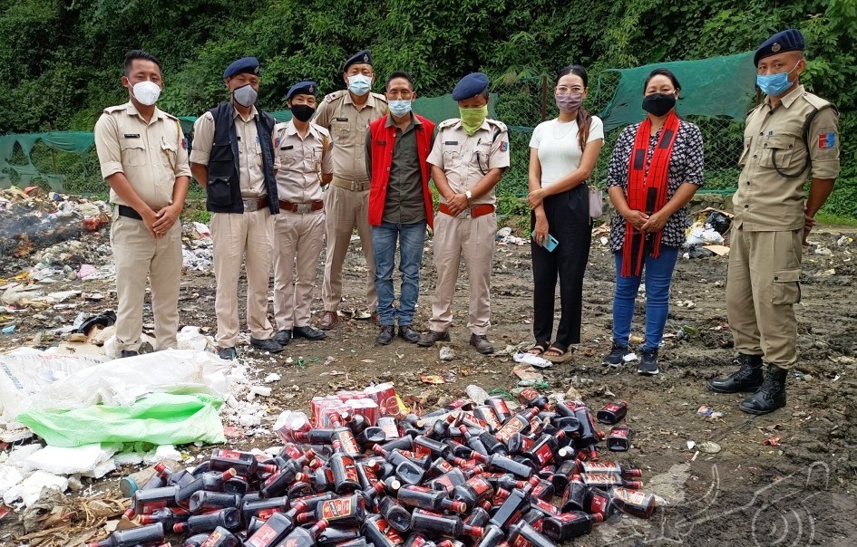 Tuensang District administration and police along with court staff, Chang Women Organization and DB destroyed the sized IMFL at dumping ground in the presence of EAC Tuensang, Ketsintle Tep on July 27. (DIPR Photo) 